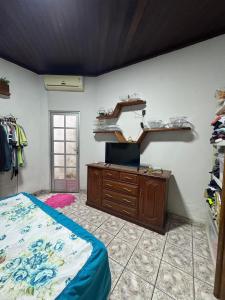 a bedroom with a bed and a dresser in a room at Excelente casa a 700 m da COP30 in Belém