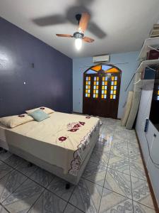 a bedroom with a bed and a ceiling fan at Excelente casa a 700 m da COP30 in Belém