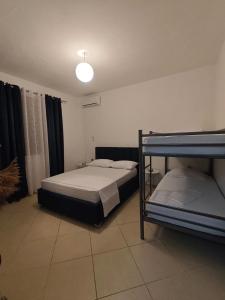 a bedroom with two bunk beds and a light at Asja's Apartment Vlore in Vlorë