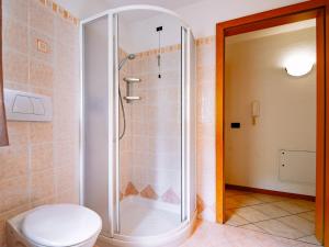a bathroom with a shower with a toilet at Apartment Delago by Interhome in Pera