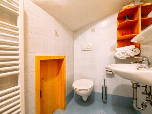 a bathroom with a toilet and a sink at Apartment Delago by Interhome in Pera +32 photos