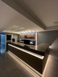 a lobby with a bar with two chairs in it at Hotel Place Jardin in Garanhuns