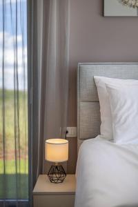 a bed with a lamp next to a window at Villa Stella by Interhome in Brtonigla