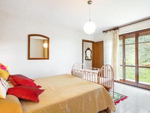 a bedroom with a bed with red pillows and a mirror at Holiday Home La Sperduta by Interhome in Montignoso +27 photos