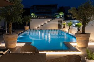 a swimming pool in a hotel at night at Vila Kalina Apartments in Sutomore