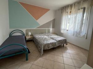 a room with two beds and a table and a window at Apartment Solaris-1 by Interhome in Rosolina Mare