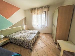 a bedroom with a bed and a window at Apartment Solaris-1 by Interhome in Rosolina Mare +6 photos