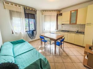 a small kitchen with a table and a table and chairs at Apartment Solaris-1 by Interhome in Rosolina Mare