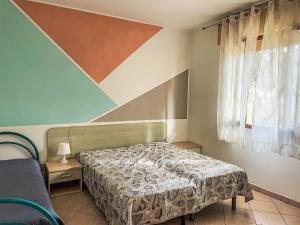 a small bedroom with a bed and a window at Apartment Solaris-1 by Interhome in Rosolina Mare