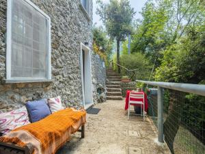a patio with a couch and a table and stairs at Holiday Home Vincio by Interhome in Culla