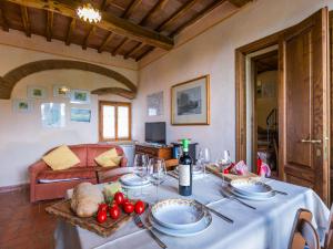a dining room with a table with plates and wine glasses at Holiday Home San Rocco-3 by Interhome in Greve in Chianti +59 photos