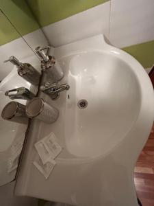 a white sink with two faucets on a toilet at Apartments Bílina in Teplice