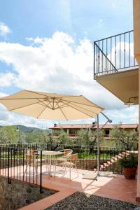 a patio with a table and an umbrella at Holiday Home Montechioccioli-4 by Interhome in Gaiole in Chianti