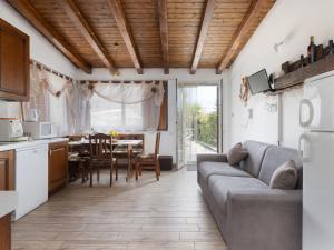 a kitchen and living room with a couch and a table at Apartment Arancio by Interhome in Zafferana Etnea