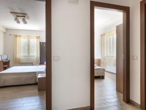 a bedroom with a bed and a mirror at Apartment Arancio by Interhome in Zafferana Etnea