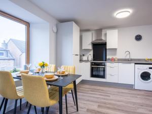 a kitchen and dining room with a table and chairs at Apartment Harbour Nights 7F by Interhome in Lossiemouth