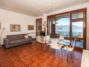 a living room with a couch and a table and chairs at Apartment Endine by Interhome in Stresa