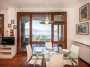 a dining room with a glass table and chairs at Apartment Endine by Interhome in Stresa