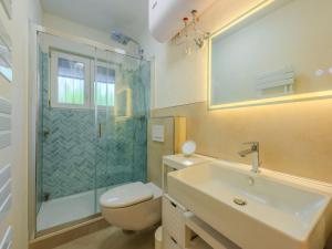 a bathroom with a toilet and a sink and a shower at Apartment Neumann by Interhome in Riva del Garda