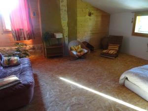 a living room with a couch and a chair at chambre chez l'habitant in Les Bordes-sur-Arize