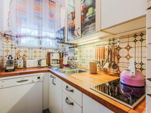 a kitchen with white cabinets and a sink at Apartment Neumann by Interhome in Riva del Garda