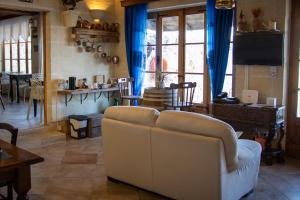 a living room with a white couch and a table at Il figolla farmhouse in Xagħra