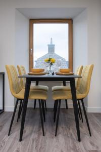 a dining room table with chairs and a window at Apartment Harbour Nights 7E by Interhome in Lossiemouth