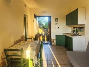 a small kitchen with a table and a sink at Apartment I Castellari by Interhome in Ranzi +22 photos