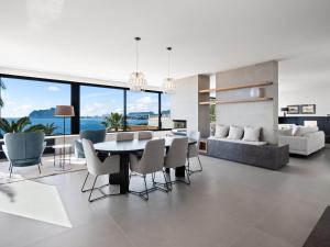 a dining room and living room with a table and chairs at Villa Cabo de Gata by Interhome in Moraira