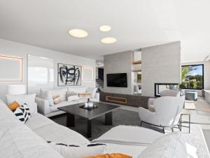 a living room with white furniture and a tv at Villa Cabo de Gata by Interhome in Moraira +45 photos