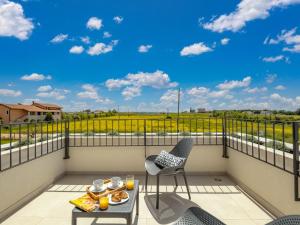 a balcony with a table and chairs and a view at Villa Stella & Alba by Interhome in Brtonigla
