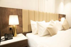 Postel nebo postele na pokoji v ubytování Nars Plus Al Naeem Hotel