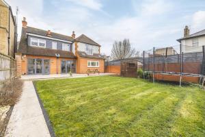 a backyard of a house with a lawn at Spacious 5BR Home, Parking, Walk to Windsor in Windsor