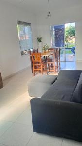 a living room with a table and chairs and a couch at La Pasionaria, casa de descanso en villa El Dique in Rosario de Lerma