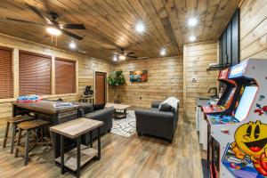 a gaming room with a pinball machine and a table at Sleeps 14 - Indoor Pool, Hot Tub, Arcade Games, Movie Theatre and Pets Welcome in Pigeon Forge