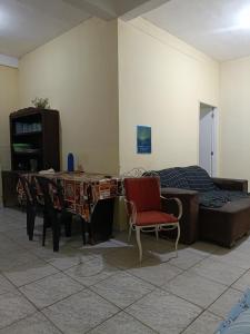 a room with a bed and a table and a chair at Cantinho e Sossego 04 in Vespasiano +1 photo