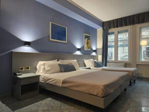 Giường trong phòng chung tại Hotel Vitruvio