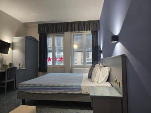 Giường trong phòng chung tại Hotel Vitruvio
