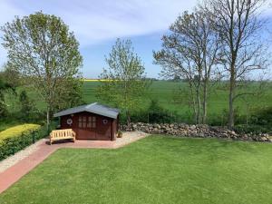 a smallshed with a bench in the grass at Ferienwohnung Weitblick in Schlagsdorf in Schlagsdorf