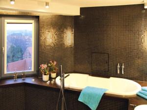 a bathroom with a bath tub and a window at Ferienwohnung im Wasserturm, Güstrow in Güstrow +13 photos