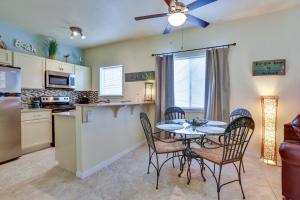 a kitchen and dining room with a table and chairs at Padre Island Condo with Pool Access - Walk to Beach! in Corpus Christi
