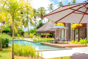 a villa with a swimming pool and a resort at Flat with Direct Pool Access in Japaratinga