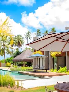 a villa with a swimming pool and a resort at Flat with Direct Pool Access in Japaratinga