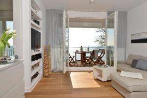 a living room with a couch and a table at Penthouse Ostseeresidenz in Sassnitz