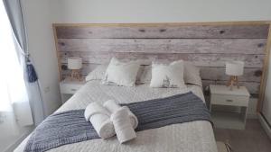 a bedroom with a large bed with two night stands at Ameli in Neuquén