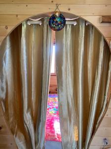 a large curtain in a room with a window at Roulotte creusoise in Verneiges +7 photos