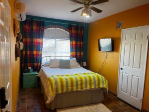 a bedroom with a bed and a ceiling fan at Crash & Go - Hotel Style Room in San Felipe