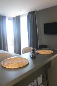 two large bread pizzas sitting on top of a table at Entrevid suite & spa in Ciudad Lujan de Cuyo