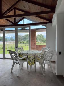 a dining room with a table and chairs at Casa campestre familiar in Guasca