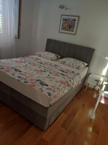 a bed in a small room with a bed sidx sidx sidx at Apartment Ela with private jacuzzi in Podgora +32 photos